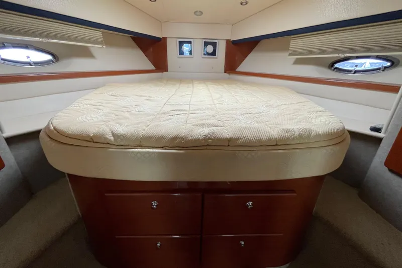  Yacht Photos Pics Interior cabin of a 2009 Formula 45 Yacht with a cozy bed and portholes.