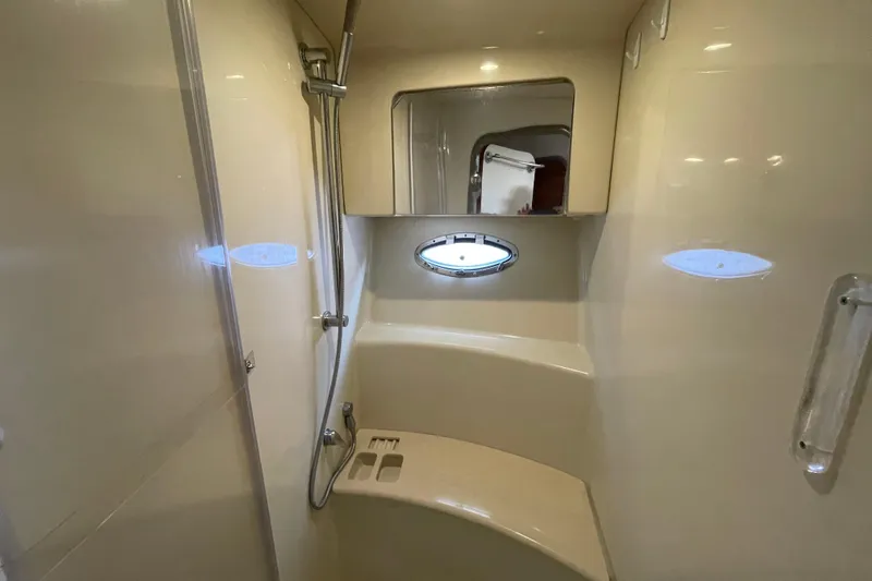 Yacht Photos Pics 2009 Formula 45 Yacht bathroom with shower, porthole, and beige interior.