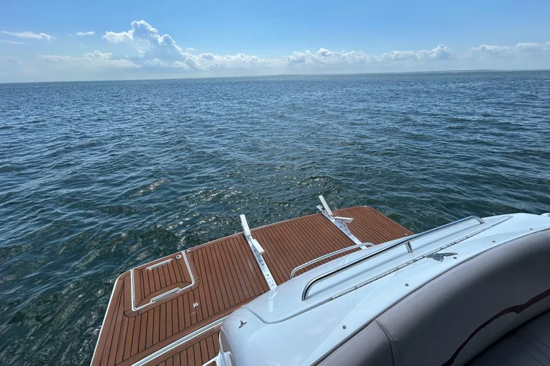  Yacht Photos Pics 2009 Formula 45 Yacht on open sea with wooden deck and clear sky.