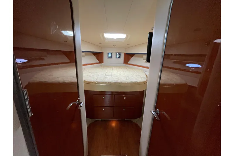  Yacht Photos Pics Luxurious interior of 2009 Formula 45 Yacht with cozy bed and wooden cabinetry.