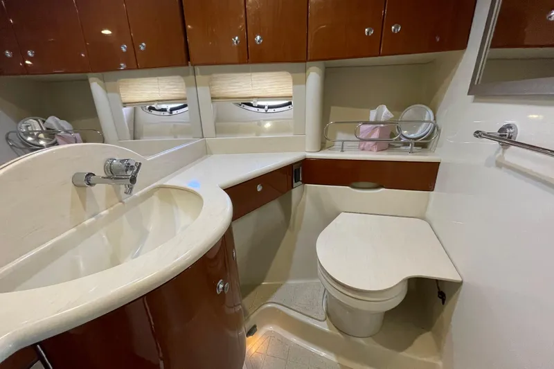  Yacht Photos Pics Luxurious bathroom interior of a 2009 Formula 45 Yacht, featuring elegant wood cabinetry.