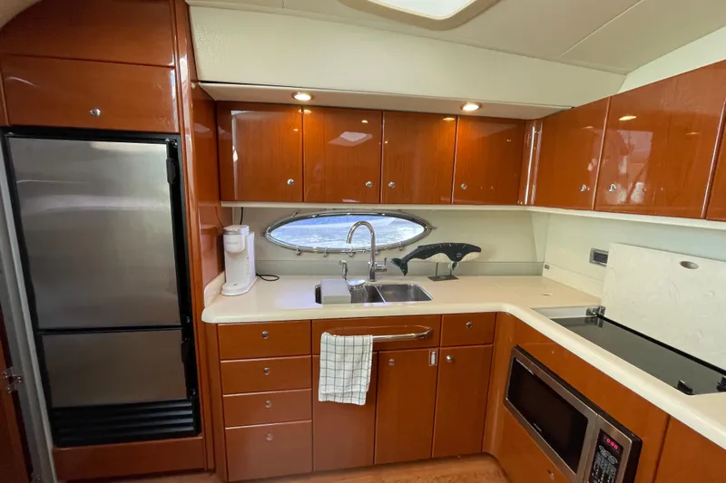 Yacht Photos Pics Luxurious kitchen interior of a 2009 Formula 45 Yacht with wood cabinetry and modern appliances.