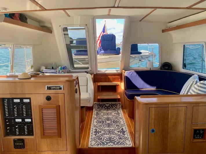 Tranquility Base Yacht Photos Pics Interior of 2003 PDQ-34 boat with wooden cabinetry, blue seating, and nautical decor.