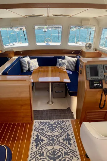 Tranquility Base Yacht Photos Pics Interior of 2003 PDQ-34 boat with wooden finish, blue seating, and ocean view.