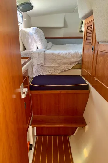 Tranquility Base Yacht Photos Pics Cozy cabin interior of 2003 PDQ-34 boat with wooden steps and bed.