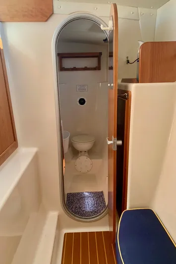 Tranquility Base Yacht Photos Pics Compact bathroom in 2003 PDQ-34 boat, featuring a toilet and wooden accents.