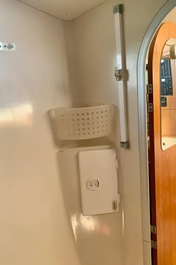 Tranquility Base Yacht Photos Pics Interior of a 2003 PDQ-34 boat showing a storage compartment and basket.