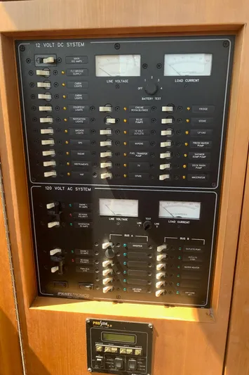 Tranquility Base Yacht Photos Pics Electrical panel on a 2003 PDQ-34 boat, featuring 12V DC and 120V AC systems.