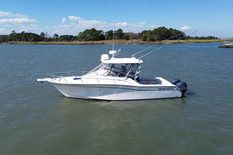 Get Bent Yacht Photos Pics 2005 Grady-White Express 330 boat on calm water with scenic background.