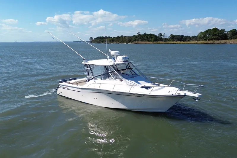 Get Bent Yacht Photos Pics 2005 Grady-White Express 330 boat on calm water under a clear blue sky.