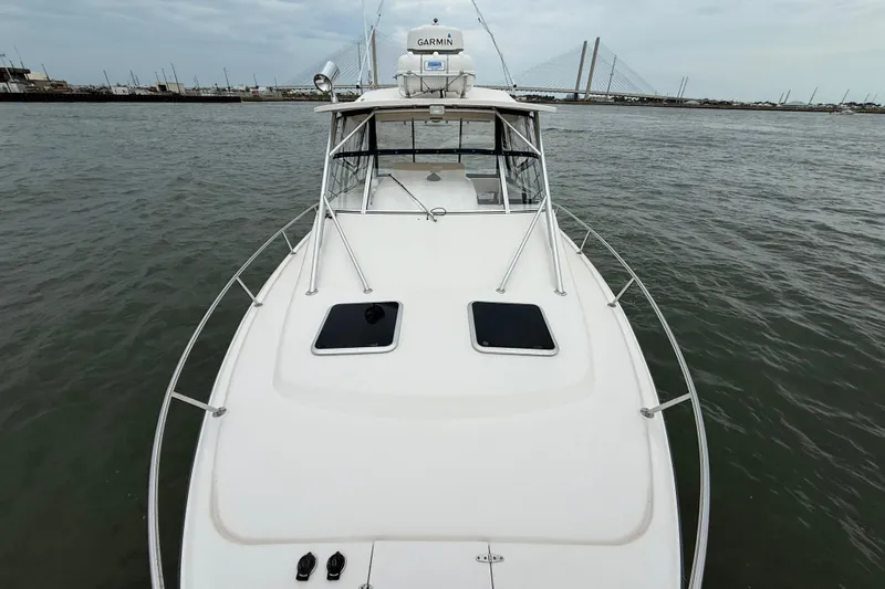 Get Bent Yacht Photos Pics 2005 Grady-White Express 330 boat on water, bridge in background, overcast sky.