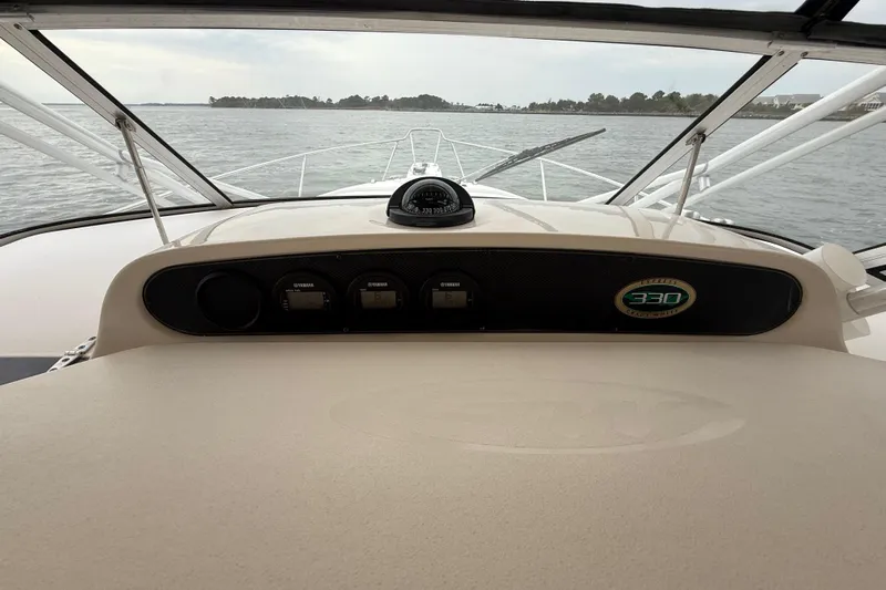 Get Bent Yacht Photos Pics 2005 Grady-White Express 330 boat dashboard with compass, gauges, and open water view.