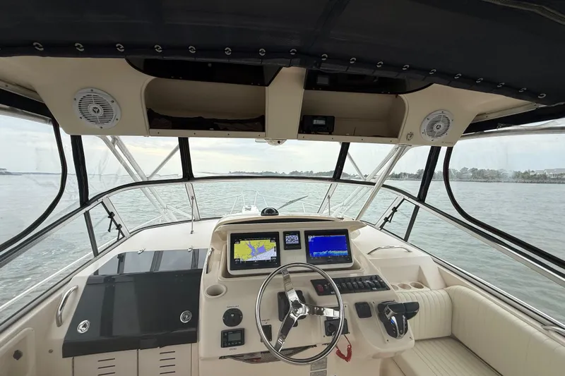 Get Bent Yacht Photos Pics 2005 Grady-White Express 330 boat cockpit with navigation screens and steering wheel.