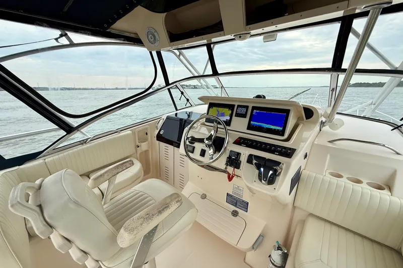 Get Bent Yacht Photos Pics 2005 Grady-White Express 330 boat cockpit with steering wheel and navigation screens.
