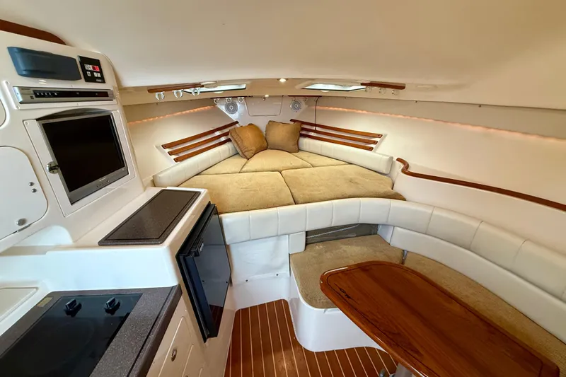 Get Bent Yacht Photos Pics 2005 Grady-White Express 330 cabin interior with cozy seating and kitchenette.