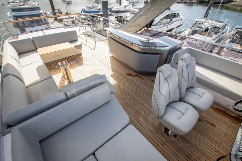 Mc Yacht Photos Pics Luxurious 2021 Princess Y78 Motor Yacht deck with elegant seating and scenic marina view.