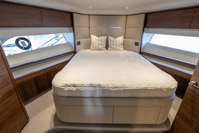 Mc Yacht Photos Pics Luxurious bedroom interior of 2021 Princess Y78 Motor Yacht with elegant wood finishes.