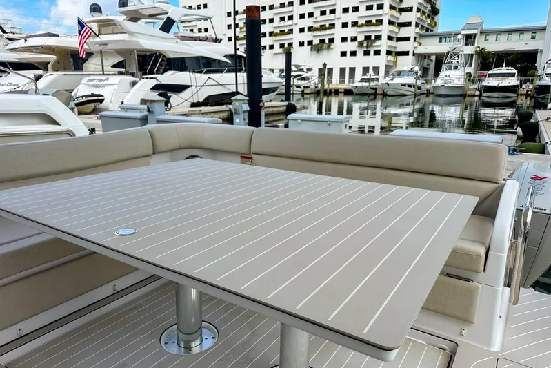 Yacht Photos Pics Azimut Verve 47 yacht interior, 2023 model, featuring a sleek dining area at a marina.