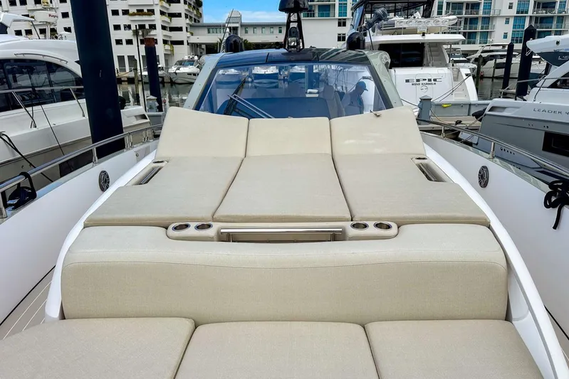  Yacht Photos Pics 2023 Azimut Verve 47 yacht with luxurious sunbathing deck in marina setting.