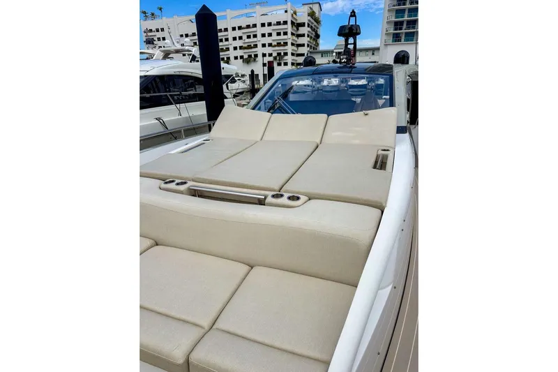  Yacht Photos Pics 2023 Azimut Verve 47 yacht with luxurious sunbathing deck in marina setting.
