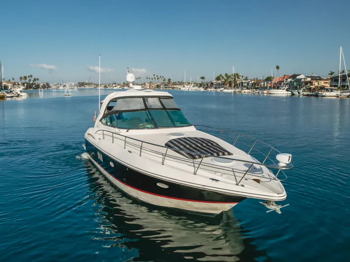 Eurybia Yacht Photos Pics 2006 Cruisers Yachts 420 Express on calm water, clear sky, marina background.
