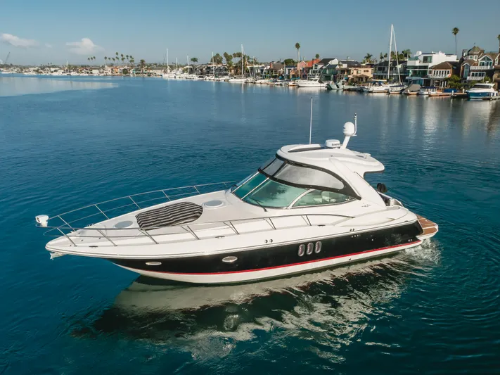 Eurybia Yacht Photos Pics 2006 Cruisers Yachts 420 Express on calm water near a marina.