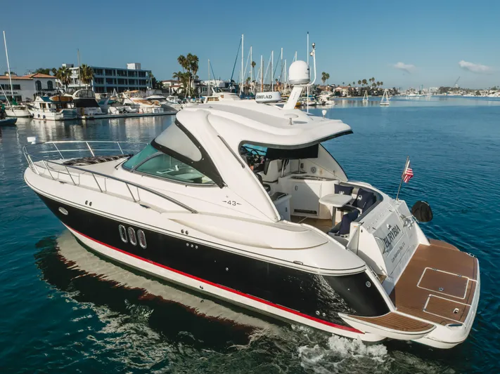 Eurybia Yacht Photos Pics 2006 Cruisers Yachts 420 Express on calm water, docked in a marina.