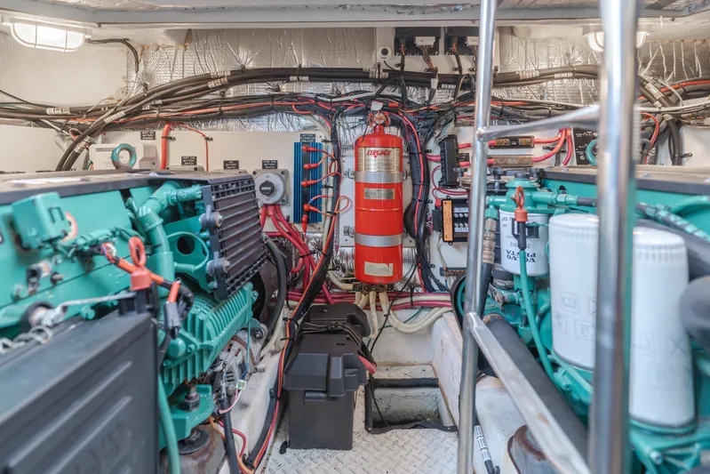 Eurybia Yacht Photos Pics Engine room of 2006 Cruisers Yachts 420 Express with visible machinery and fire extinguisher.