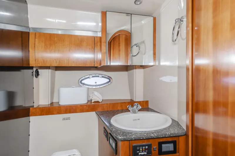Eurybia Yacht Photos Pics 2006 Cruisers Yachts 420 Express bathroom with wood cabinetry and modern fixtures.