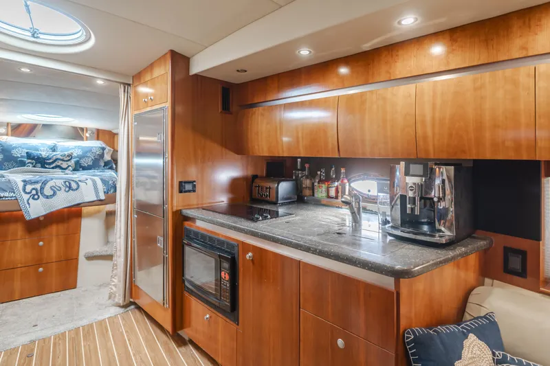 Eurybia Yacht Photos Pics Luxurious 2006 Cruisers Yachts 420 Express interior with modern kitchen amenities.