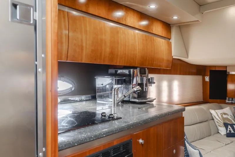 Eurybia Yacht Photos Pics 2006 Cruisers Yachts 420 Express interior with modern kitchen and cozy seating area.