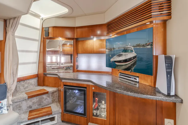 Eurybia Yacht Photos Pics Interior of 2006 Cruisers Yachts 420 Express with modern kitchen and wooden cabinetry.