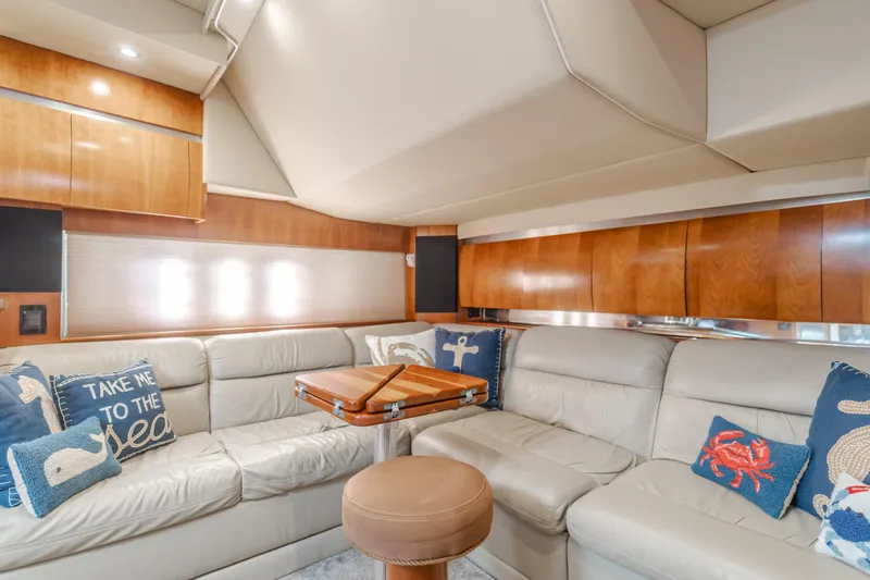 Eurybia Yacht Photos Pics Luxurious interior of 2006 Cruisers Yachts 420 Express with plush seating and nautical-themed decor.