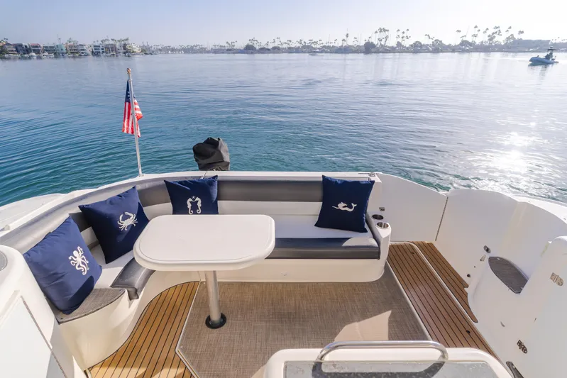 Eurybia Yacht Photos Pics 2006 Cruisers Yachts 420 Express deck with seating, table, and ocean view.