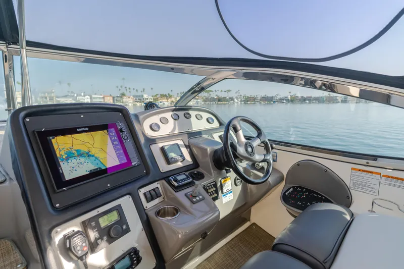 Eurybia Yacht Photos Pics Helm of 2006 Cruisers Yachts 420 Express with navigation system and steering wheel.