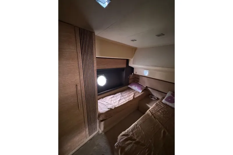  Yacht Photos Pics Luxurious cabin interior of 2012 Azimut 60 yacht with twin beds and porthole.