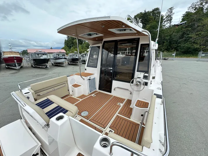  Yacht Photos Pics 2025 Ranger Tugs R29 S boat with spacious deck and seating, docked outdoors.