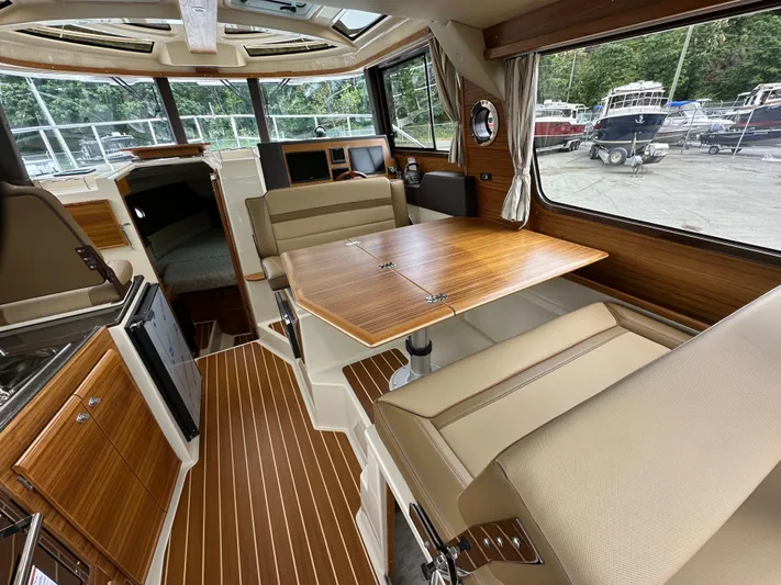  Yacht Photos Pics 2025 Ranger Tugs R29 S interior with wood accents and spacious seating area.