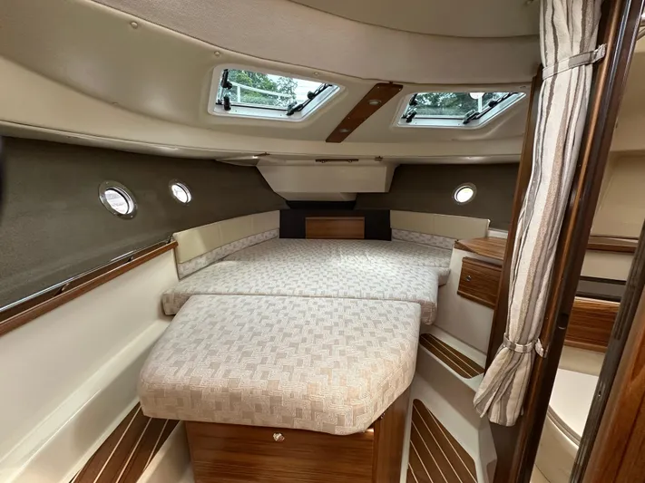  Yacht Photos Pics 2025 Ranger Tugs R29 S cabin interior with cozy bed and elegant wood finishes.