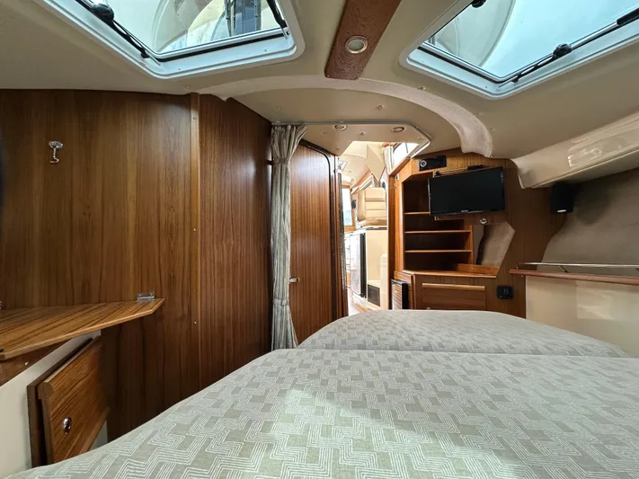  Yacht Photos Pics Interior of 2025 Ranger Tugs R29 S boat with wood paneling and cozy sleeping area.