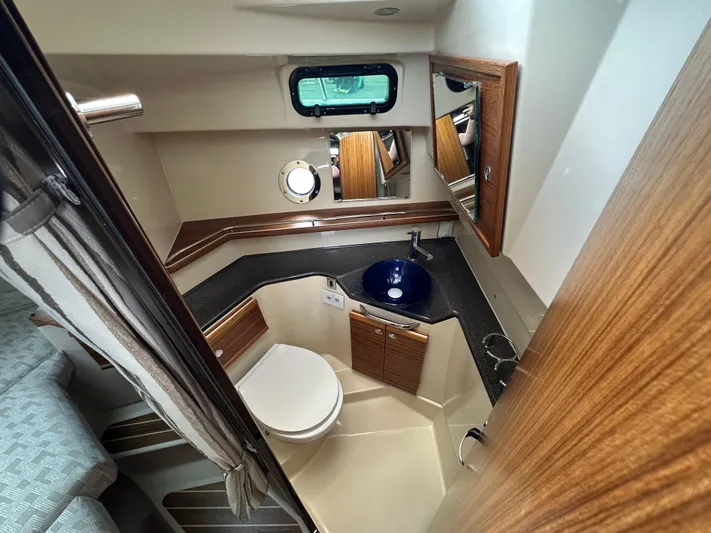  Yacht Photos Pics 2025 Ranger Tugs R29 S bathroom with modern sink, toilet, and wood accents.