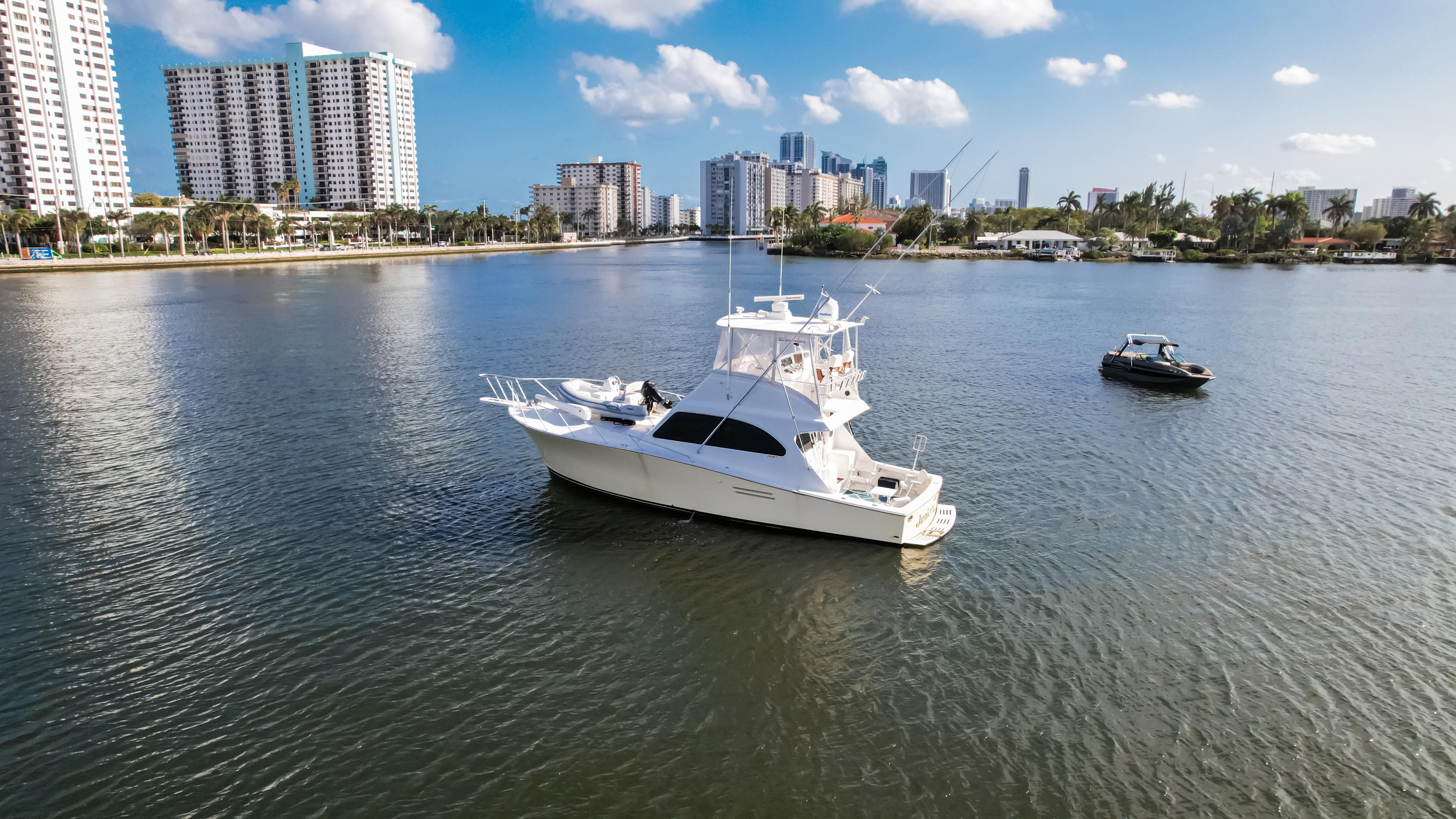 White yacht on calm water with city skyline, Post 42 model, 2008.