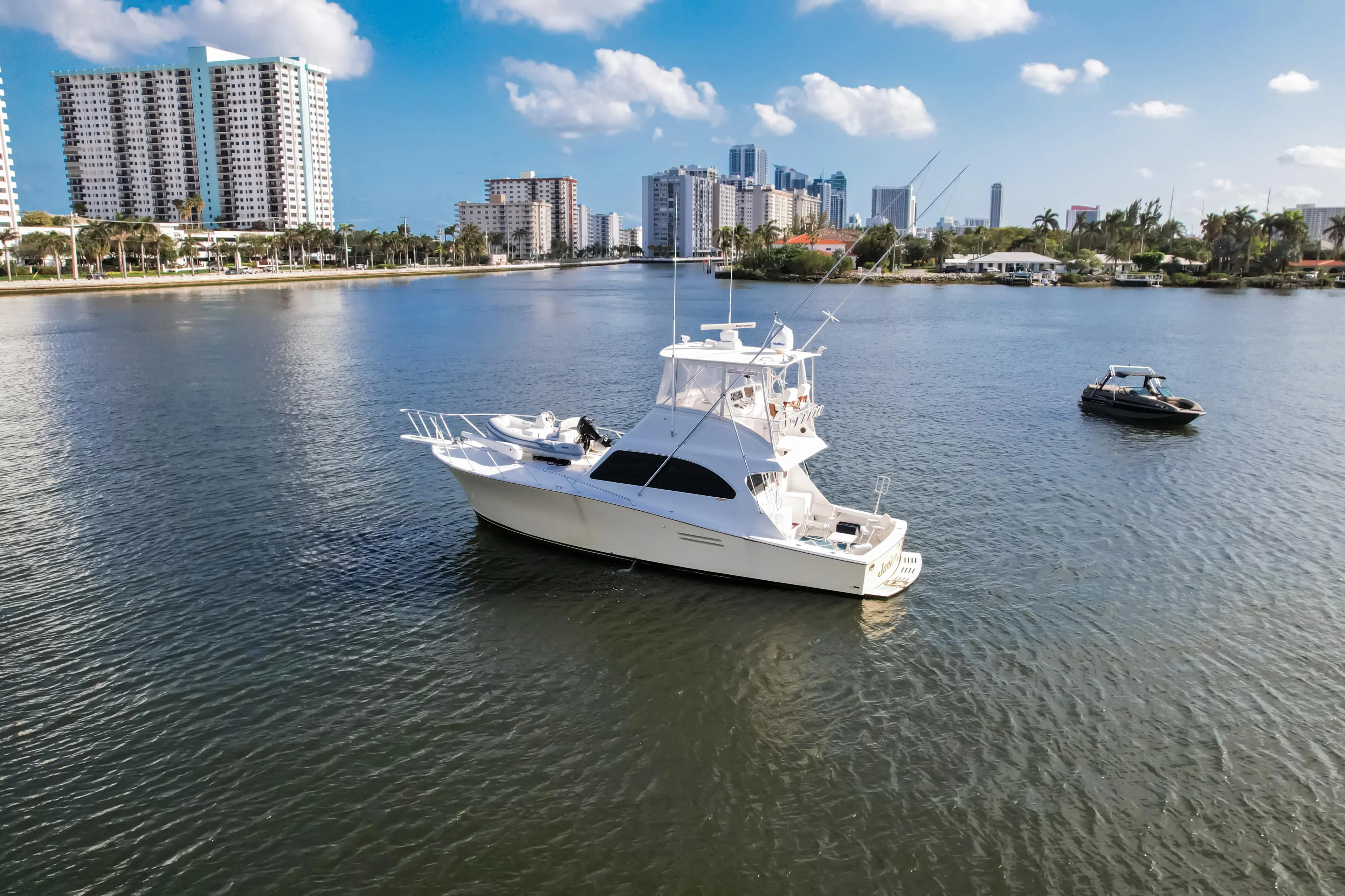 White yacht on calm water with city skyline, Post 42 model, 2008.