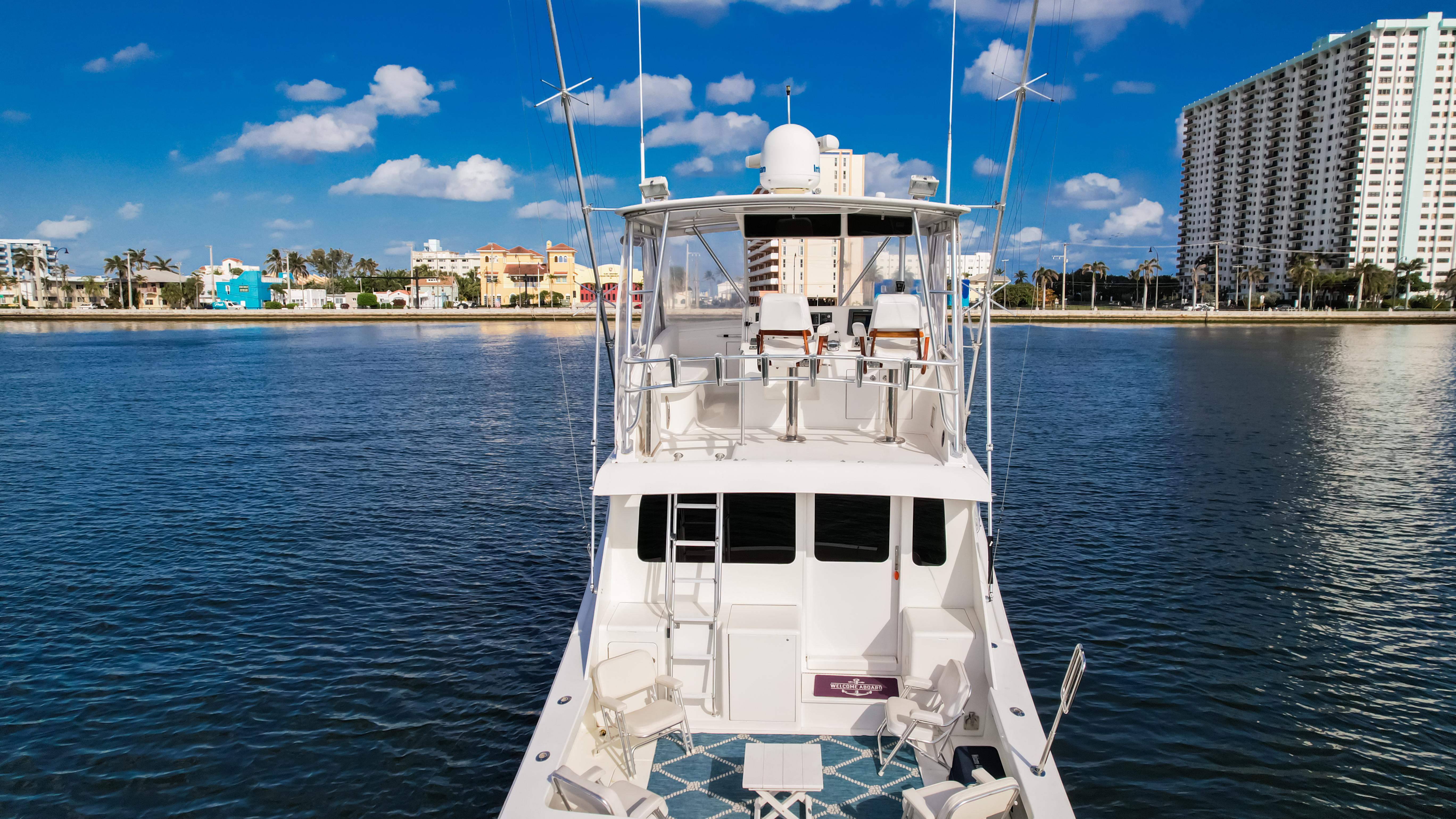 Luxury yacht on calm water with city skyline, Post 42 model, 2008.