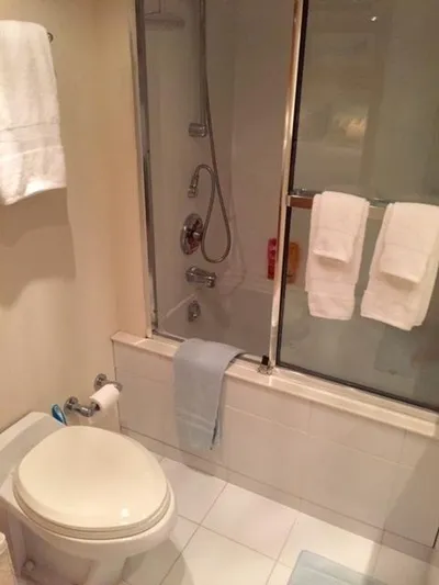 Whale's Way Yacht Photos Pics Bathroom interior of 1998 Hatteras 74 Sport Deck yacht with shower and towels.