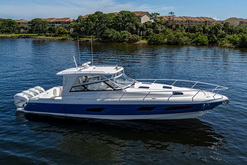  Yacht Photos Pics 2020 Intrepid 477 Evolution boat on calm water with scenic background.