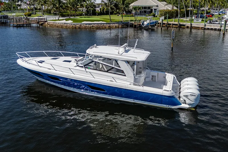  Yacht Photos Pics 2020 Intrepid 477 Evolution boat on water near dock and waterfront homes.