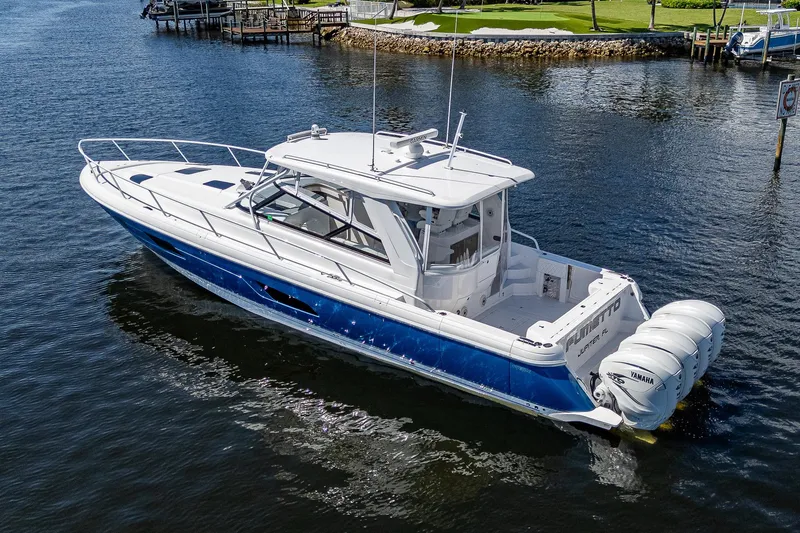  Yacht Photos Pics 2020 Intrepid 477 Evolution boat cruising on a calm waterway.