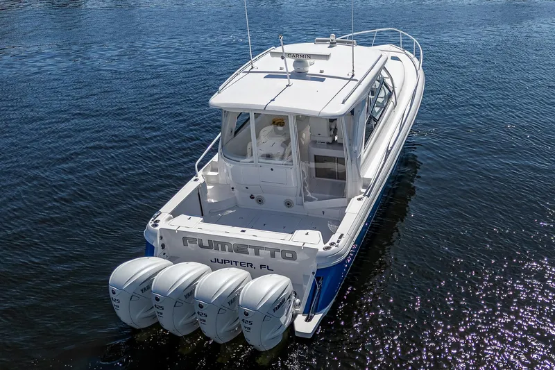  Yacht Photos Pics 2020 Intrepid 477 Evolution boat with four outboard engines on water.