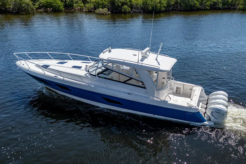  Yacht Photos Pics 2020 Intrepid 477 Evolution boat cruising on a calm river.